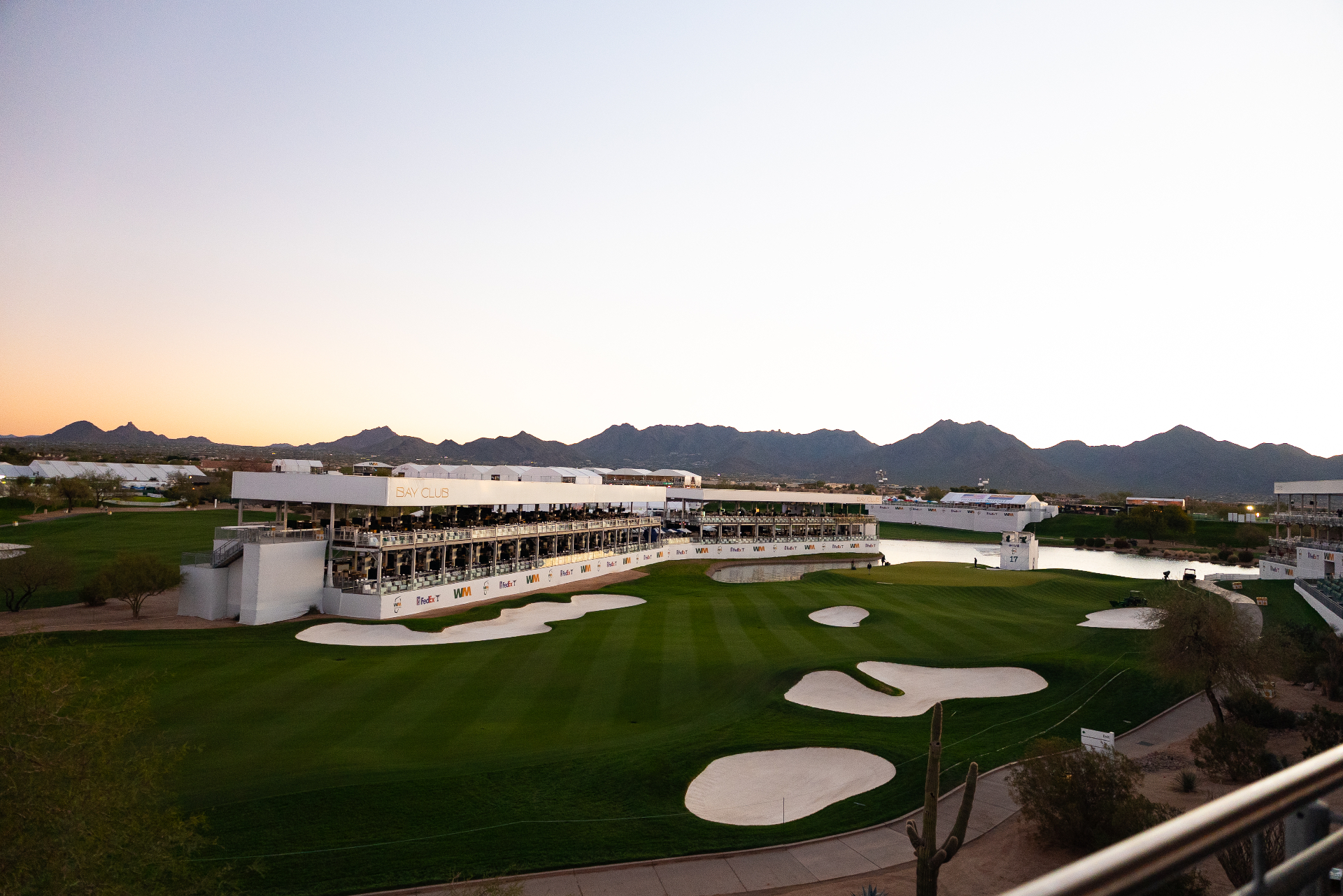 TPC Scottsdale 17th hole with crowds and mountains beyond