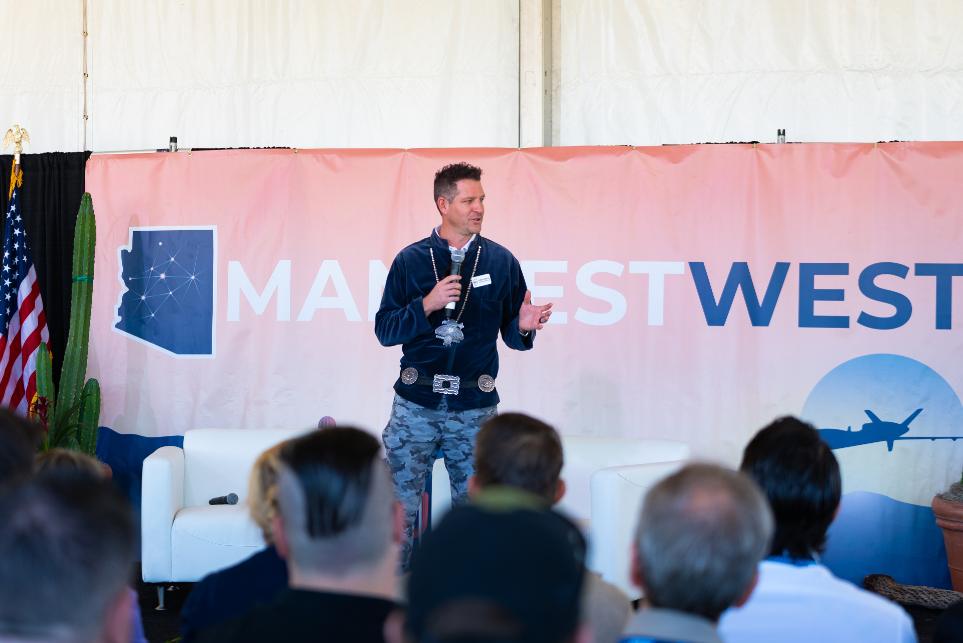 Founder speaking on stage at Manifest West