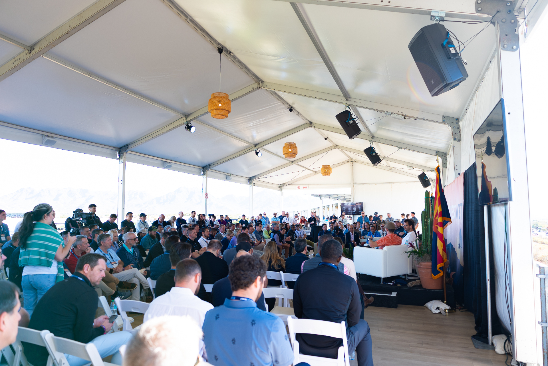 Packed audience under the tent at Manifest West